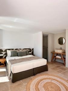 a bedroom with a large bed and a table at Egeo Paros in Kampos Paros