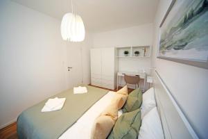a small bedroom with a bed and a desk at Apartment Fala - self check-in 0-24, fast wi fi, city center in Zagreb