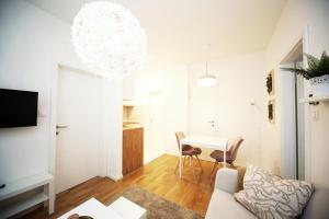 a living room with a couch and a table at Apartment Fala - self check-in 0-24, fast wi fi, city center in Zagreb