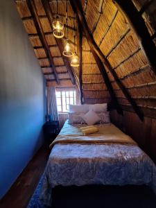 a bedroom with a bed in a wooden ceiling at Lakeview Cottage, Curry's Post - SOLAR POWERED in Howick