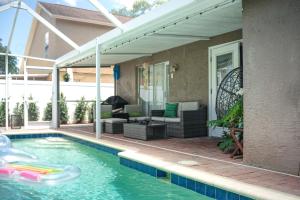 a swimming pool with a patio and a house at Pet-Friendly Valrico Vacation Home with Lanai! in Valrico