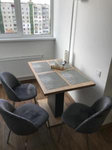 a wooden table with two chairs and a table with a toy at Light Apartments in Chernihiv
