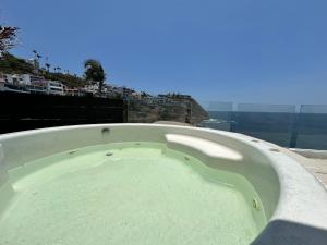 a large bath tub with a view of the ocean at Sirenas in Acapulco