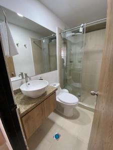 a bathroom with a sink and a toilet and a shower at Caliview Apartahotel in Cali