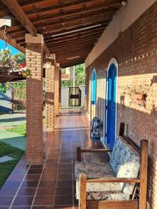a porch with a bench on a brick building at Villa Brisa Azul in Atibaia