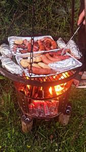 a grill with hot dogs and other food on it at Wypoczynek u Agnieszki in Ochotnica Górna