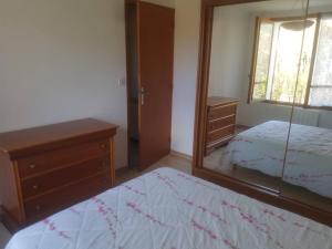 - une chambre avec un miroir, un lit et une commode dans l'établissement L Étoile du Verdon, à Saint-André-les-Alpes