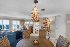 a living room with a table and a couch at Pinnacle Port C1-302 in Carillon Beach