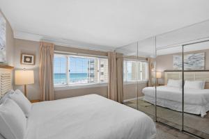 a bedroom with two beds and a large window at Pinnacle Port C1-302 in Carillon Beach +66 photos