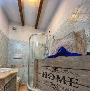 a bedroom with a bed and a shower and a sink at Casa L ulivo in Santa Maria Navarrese