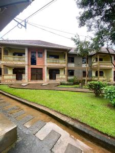 a building with a walkway in front of it at Queens apartments in Entebbe