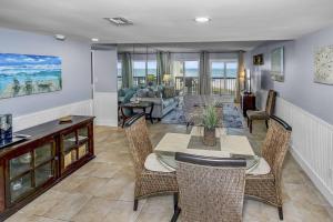 a living room with a table and chairs at Pinnacle Port B3-307 in Carillon Beach