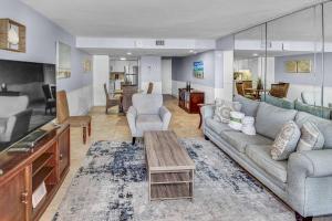 a living room with a couch and a table at Pinnacle Port B3-307 in Carillon Beach