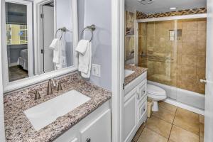 a bathroom with a sink and a toilet and a shower at Pinnacle Port B3-307 in Carillon Beach +41 photos