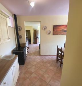 a kitchen with a stove and a dining room at Ca' Degli Ulivi Relax - uso esclusivo con jacuzzi in Lunigiana vicino cinque terre in Agnino +20 photos