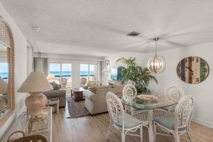 a living room with a couch and a table and chairs at Pinnacle Port C1-203 in Carillon Beach