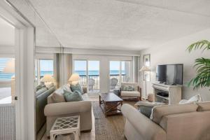 a living room with a couch and a television at Pinnacle Port C1-203 in Carillon Beach
