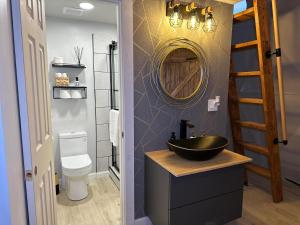 a bathroom with a black sink and a mirror at White Camel in Kanab