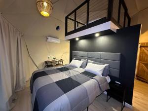 1 dormitorio con 1 cama grande y pared negra en White Camel, en Kanab