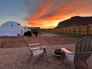 a couple of chairs and a grill and a tent at White Camel in Kanab