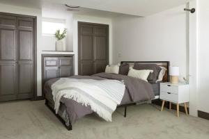 a bedroom with a large bed and a night stand at New and cozy, 2 Bedroom unit in Missoula in Missoula
