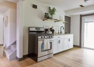 a kitchen with a stove top oven in a room at New and cozy, 2 Bedroom unit in Missoula in Missoula