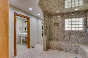 a walk in shower in a bathroom with a sink at Hornersville Vacation Rental with Private Pond! in Hornersville +33 photos