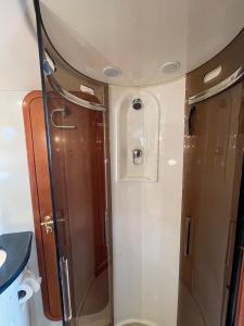 a bathroom with a shower and a toilet at Motor Boat Accommodation in Torquay