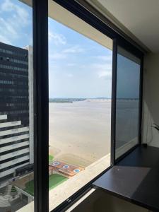 a view of the beach from a window in a building at Torres Bellini I-II in Guayaquil