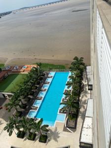 an overhead view of a resort with a swimming pool and the beach at Torres Bellini I-II in Guayaquil