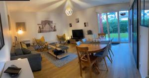 a living room with a table and a dining room at Clos ETCHBERRI in Bidart