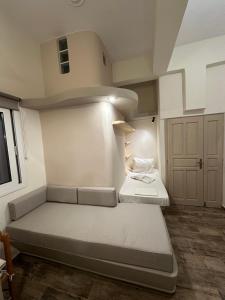 a small room with two beds in it at Afrodite Hotel in Tinos