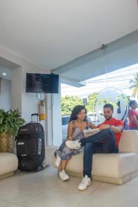 a man and a woman sitting on a couch at Hotel Central in Sincelejo