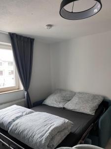 a bed in a small room with a ceiling at Gemütliche Wohnung am Bodensee - Self-CheckIn in Markdorf