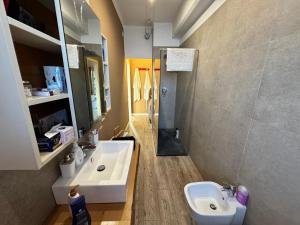 a bathroom with a white sink and a mirror at SNOOP HOUSE in Alessandria