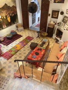 a living room with a table in the middle of a room at Bab El Fen in Tangier