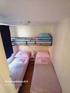 a room with two bunk beds and a window at Mobile home Relax in Klenovica