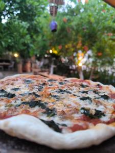 a pizza sitting on top of a table at Litost Cafe Bungalow in Adrasan