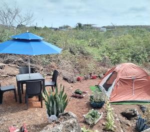 a tent and a table and chairs and a table and umbrella at Palma del Mar 2 in Puerto Baquerizo Moreno