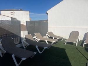 a group of chairs sitting on a patio at La Posada in Setenil