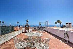 a patio with a table and chairs and the ocean at Rosarito Beach Home in Las Gaviotas with Ocean Views in Raulis