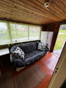 un sofá en una sala de estar en una casa en Vasaras mājiņa Nr.2, en Kaunata
