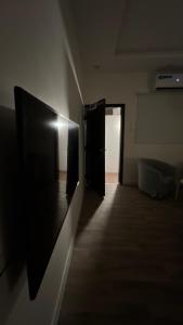 a dark room with a door and a hallway at غرفة و حوش بمدخل خاص و دخول ذكي in Riyadh