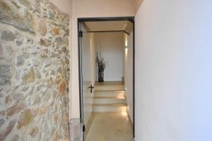 a hallway with a stone wall and a stairway at API Tenna Apartaments Betulla 2 in Tenna 