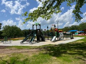 a park with a playground with a slide and swings at Beautiful Parkside Suite in Saint James