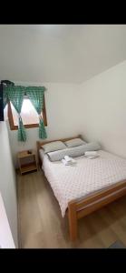 a bedroom with a large bed with a window at Konak Dobri Potok in Krupanj