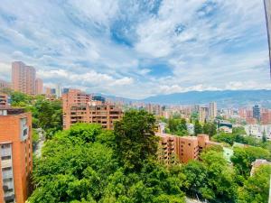 a view of a city with buildings and trees at Beautiful Apto in Poblado in Medellín