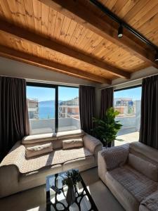 a living room with a couch and a table at Luxury Rooftop Vlora in Vlorë