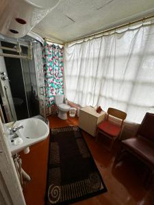 a small bathroom with a sink and a toilet at Vasaras mājiņa pie Rāznas ezera Nr 6 in Ragi