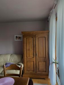 a wooden cabinet in a corner of a room at Mieszkanie Mickiewicza ... 45 in Sandomierz +26 photos